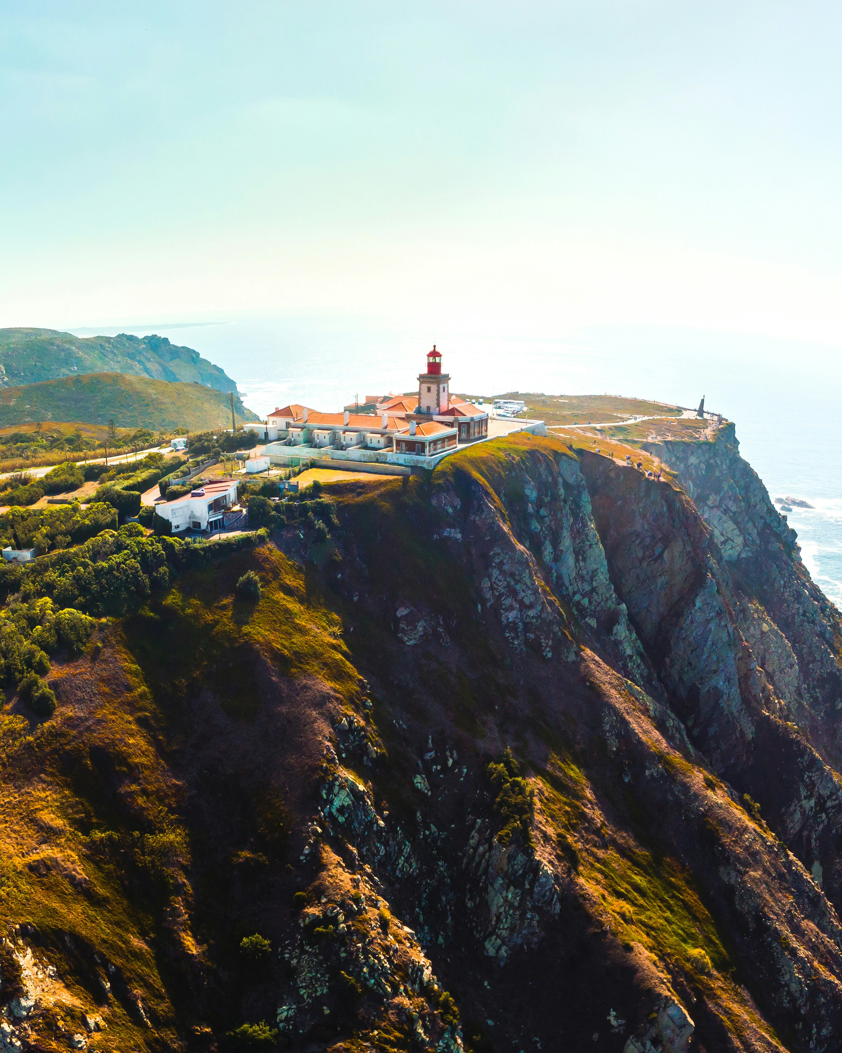 Cabo da Roca lighthouse on green cliffs above the Atlantic ocean